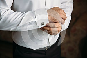 Gentlemans hands with cufflinks. Concept of business dress