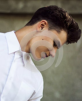 Genuine Sophisticated Young Man in White Shirt Looking Down