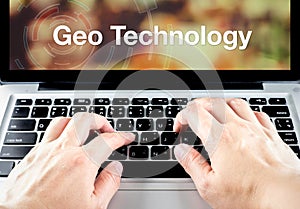 Geo Technology word on notebook screen with hand type on keyboard, Location technology concept
