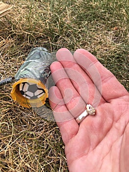 Geocaching items and adult hand closeup