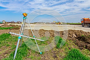 Geodesist device with leveling rod on tripod on a building site