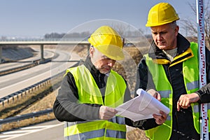 Geodesist read plans on construction site