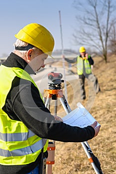 Geodesist read plans on construction site