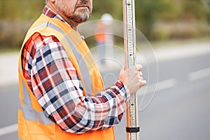 Geodesist measuring the area