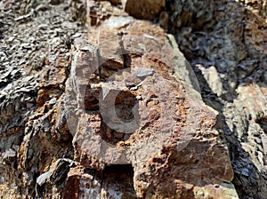 Geodesy. Stone texture. The rock is brown and red. Mineral background. Design from natural materials.