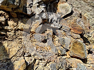 Geodesy. Stone texture. The rock is brown and red. Mineral background. Design from natural materials.