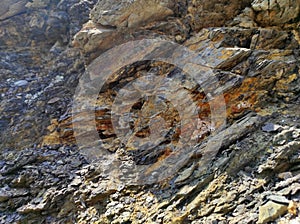 Geodesy. Stone texture. The rock is brown and red. Mineral background. Design from natural materials.