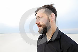 Geographer male smoking carrying out research on seaside.