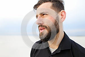 Geographer male smoking carrying out research on seaside.