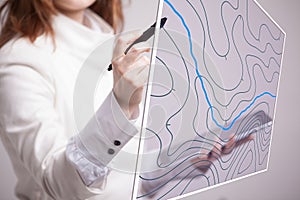 Geographic information systems concept, woman scientist working with futuristic GIS interface on a transparent screen.