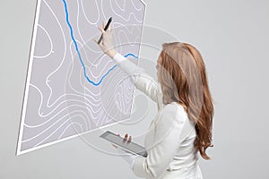 Geographic information systems concept, woman scientist working with futuristic GIS interface on a transparent screen.