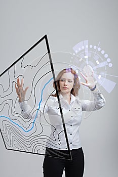 Geographic information systems concept, woman scientist working with futuristic GIS interface on a transparent screen.