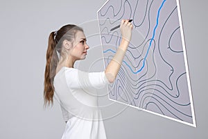 Geographic information systems concept, woman scientist working with futuristic GIS interface on a transparent screen.