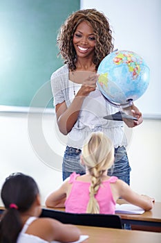 Geography, globe and teacher with children in classroom for education, world learning and happy earth knowledge. African