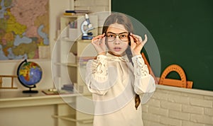 geography man on wall. Small child girl posing in school at lesson. Learning different subjects. back to school. teacher