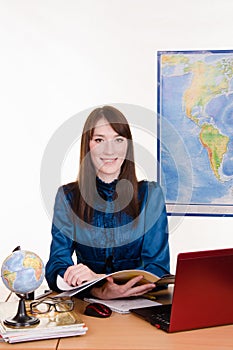 Geography teacher reading a magazine about travel