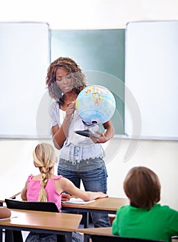 Geography, woman or teacher with children in classroom for globe education, world learning or earth knowledge. African