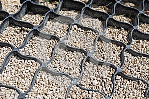 Geogrid. Geosynthetics, which is two-dimensional honeycomb structure made of strips of polyester needle-punched fabric photo