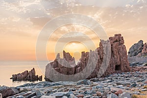 Geological feature called `Rocce rosse` red rocks along the coastline in Arbatax Sardinia, Italy at the sunrise