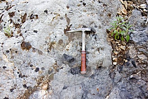 Geological hammer on the rock