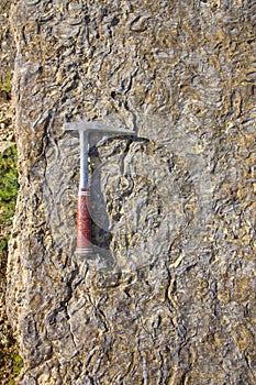 Geological hammer on the rocks
