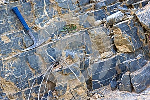 Geological hammer on the rocks