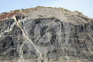 Geological outcrops with the exit of vein formations to the surface of the sea coastline photo