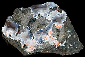Geological sample with Ð° vein of chalcedony with the inclusion of unidentified white and red zeolites in the volcanic rock