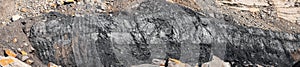 Geological section of soil, layers of coal and rock. Overburden open mine anthracite. Dark texture black color