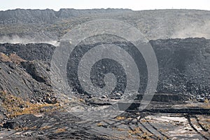 Geological section of soil, layers of coal and rock. Overburden open mine anthracite. Dark texture black color photo