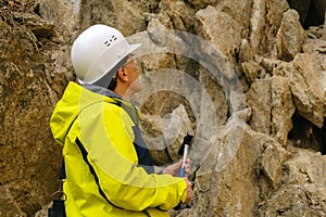 Geologist is going to take a rock sample