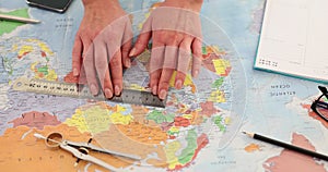 Geologist with ruler on world map