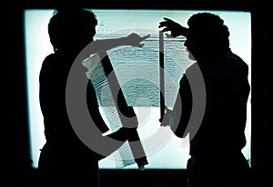 Geologists discuss seismic readouts on a vertical lightbox