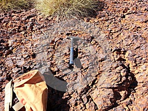 Geology pick and bag with spinifex photo