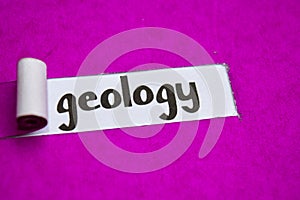 Geology text, Inspiration, Motivation and business concept on purple torn paper