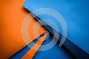 Geometric Arrangement of Colorful Papers in Blue and Orange Tones with Light and Dark Background.