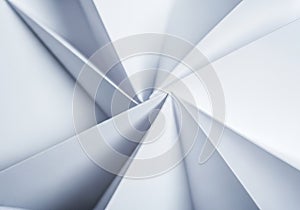 Geometric composition of white folded paper creating sharp, triangular patterns in a