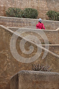 Geometric concrete stair with woman in red. Perspective outdoor scene