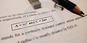 geometric equation of area and circle written on white paper sheet