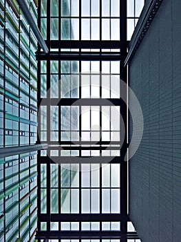 Geometric glass roof canopy under a skyscraper