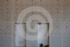 Mashrabiya screen pattern in metal panel over a building