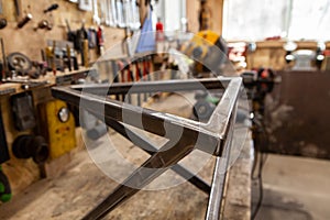 Geometric metal frame inside a workshop