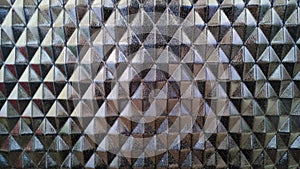 Geometric metallic triangles pattern creating a reflective surface.