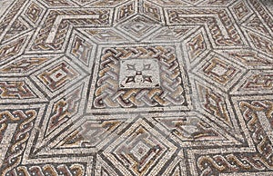 Geometric mosaic of the roman ruins of the ancient city of Conimbriga, Beiras region, Portugal photo