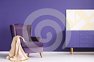 Geometric painting on a purple cabinet in elegant living room in