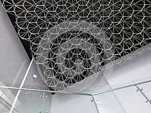 Geometric pattern of stainless steel ceiling decoration inside of modern building
