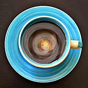 Geometric patterns - top view of the circulating coffee in a circular cup