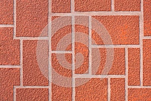 Geometric rectangle pattern of decorative roughness orange concrete texture on surface of gypsum board wall in vintage style