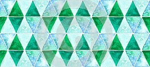 Geometric seamless pattern of blue-green triangles, green, teal and blue watercolor paint texture background