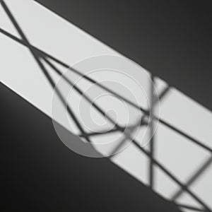 Geometric shadow patterns are cast on a gray surface, formed by a light source shinin